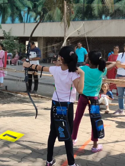 Two young girls shooting side by side. We foster a healthy sense of competition and camaraderie among our young archers.