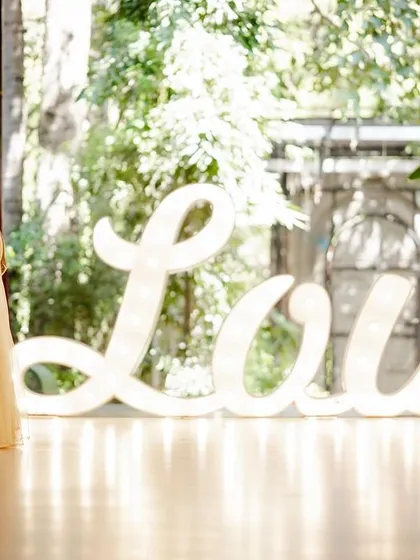 This large, illuminated "Love" sign is a fantastic prop for indoor or covered spaces. It adds a bold, romantic statement and beautiful soft lighting to your photos.