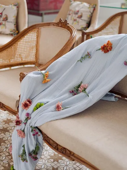 It's all in the little details. For this engagement, we created custom throws by individually stitching each flower onto the fabric. This level of detail elevates a simple seating arrangement into a bespoke experience.
