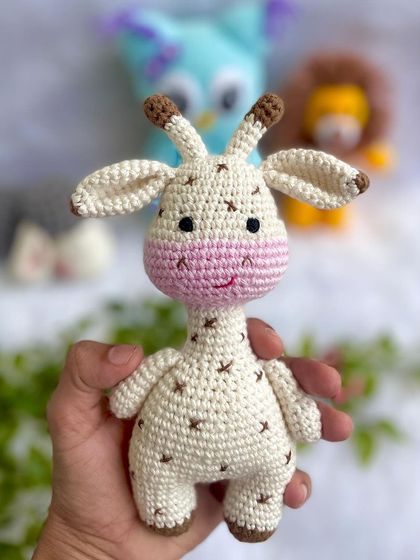 A close-up of the mini giraffe from the baby's first toy set. Its small size is perfect for little hands to hold.