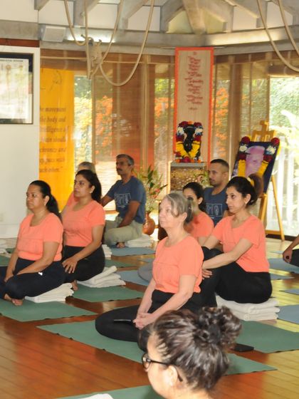Students sit in quiet contemplation at the start of a class during our Annual Day celebration. This moment of stillness is just as important as the active asanas.