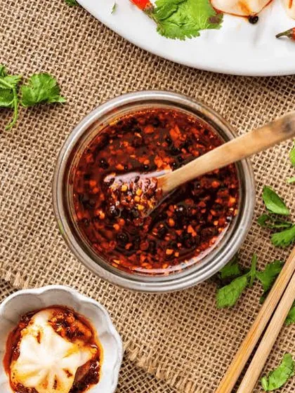 A jar of my Chilli Garlic Shrimp Oil, perfect for dipping or as a cooking ingredient. You can see the texture from the chilli flakes, garlic, and shrimp.