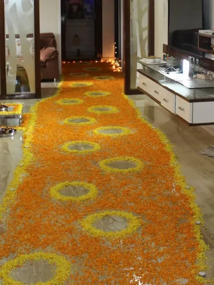 A welcome home surprise should be grand. I designed this beautiful floral pathway using fresh marigold petals in orange and yellow, leading up to the main event area and creating a traditional and heartfelt entrance.