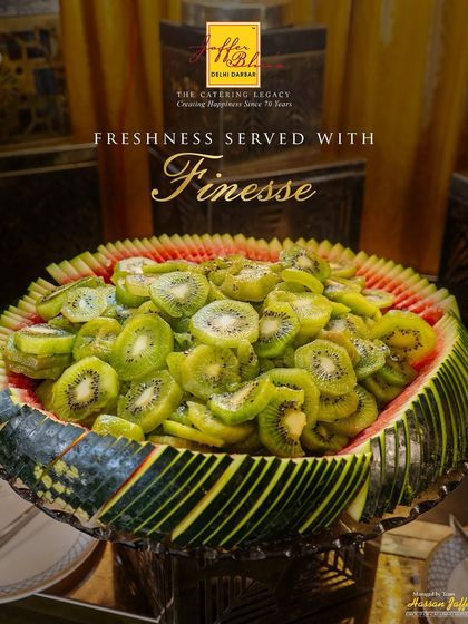 Freshness served with finesse. A simple yet elegant display of sliced kiwi in a carved watermelon bowl, showing our attention to detail even in the simplest offerings.