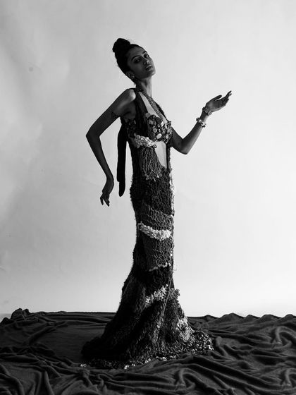 A duplicate of 261, this black and white shot emphasizes the dress's silhouette and the model's elegant pose.