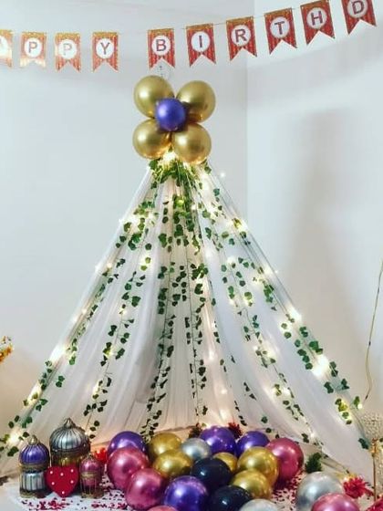 The teepee tent filled with colorful balloons, ready for the birthday surprise.