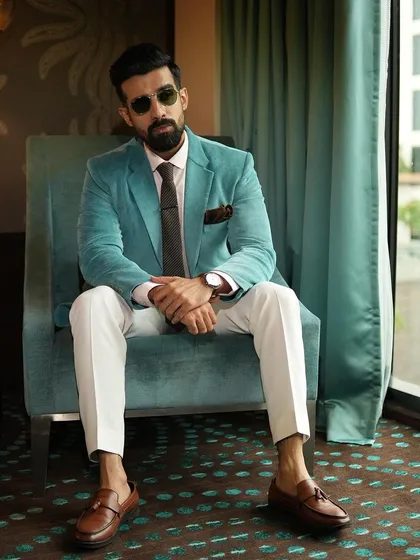 We love experimenting with color and texture to match our client's personality. This vibrant aqua corduroy blazer, paired with crisp white trousers, is a prime example of how we create custom statement pieces that are perfect for both work and weekend style.