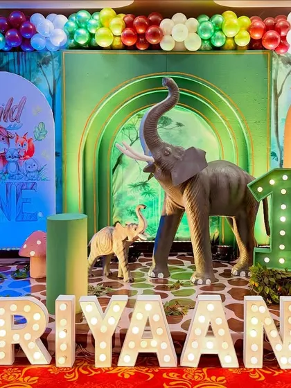 Personalization is key. Here, I've added large, light-up marquee letters with the birthday boy's name, Hariyaansh, right in front of the main jungle stage for a personalized touch.