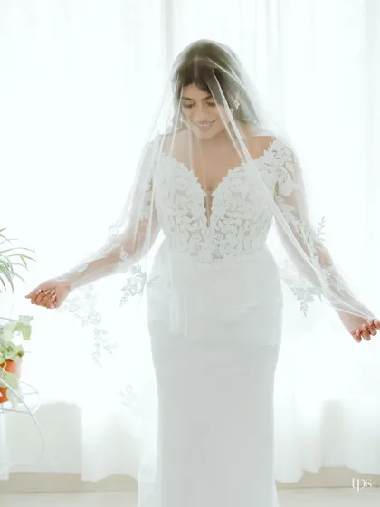 A dreamy shot of the bride under her veil, creating a soft and romantic mood.