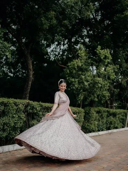 A joyful bridal portrait capturing a twirl. The movement of the lehenga and the bride's happy expression create a dynamic and beautiful image.