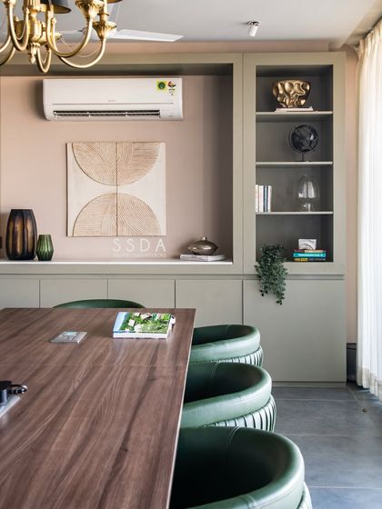 Our office conference room, where we collaborate and welcome clients. The design, with its green leather chairs and custom cabinetry, reflects our studio's aesthetic and attention to detail.