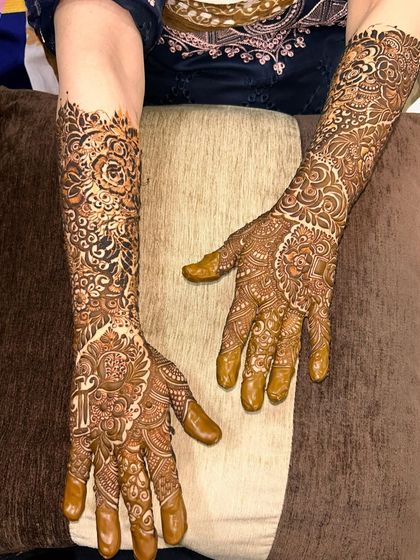 A full bridal design with a focus on intricate patterns and personalized initials. The design is different on each hand but complements the other perfectly.