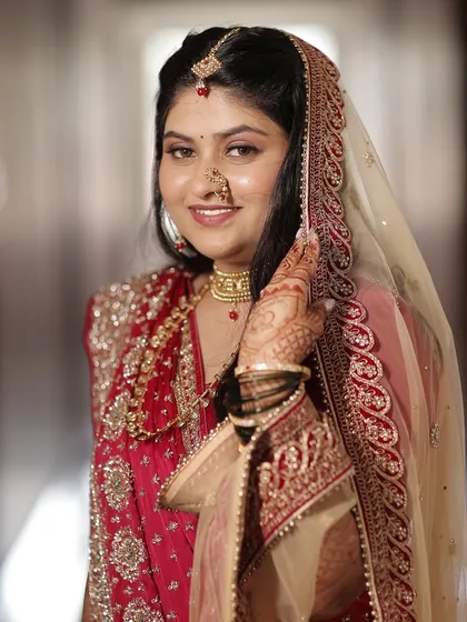 A close-up portrait. The soft makeup and elegant jewellery create a look of timeless grace.