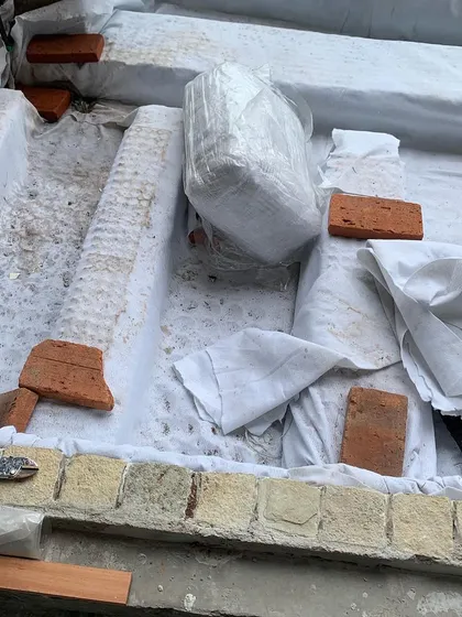 Preparing the foundation for a large planter bed. We use a waterproofing layer and drainage cells to ensure the structure is sound and the plants stay healthy.