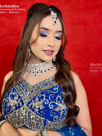 This engagement look features elegant blue nails with a subtle shimmer, designed to match the royal blue lehenga and diamond jewelry.