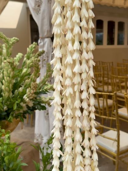 A close-up of a beautiful tuberose garland, showcasing the delicate texture and traditional floral work that is central to heritage decor.