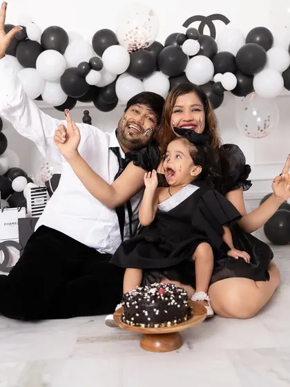 Celebrations should be full of life and personality. This family is having a blast during a Chanel themed cake smash session, complete with a custom balloon arch and designer props provided by our studio.