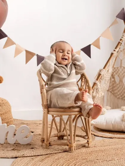 Even little moments of fussiness can be adorable. This candid shot captures a real, unposed expression during his fun-filled first birthday session.