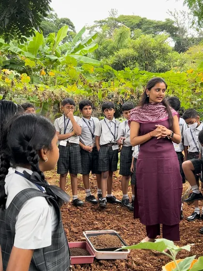 Our trainer leads a session with students in the open field, explaining the basics of soil health and planting. These outdoor classrooms provide an unforgettable, practical learning experience.