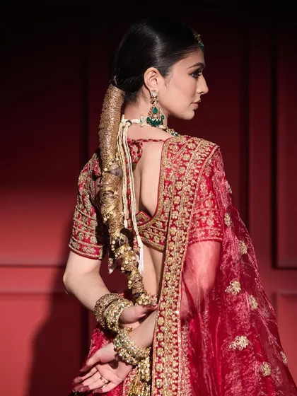 A side view of the traditional gota braid. The intricate wrapping and the ghungroo details create a rich texture that is perfect for a bridal look.