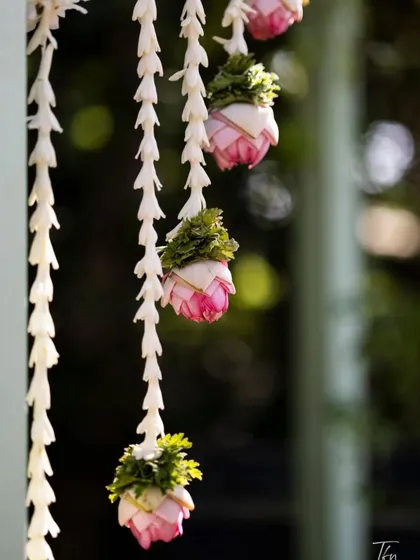 A close-up look at the quality of our floral work. These are delicate hanging garlands made of fresh jasmine and pink lotus buds, perfect for adding an elegant and traditional touch to any decor.