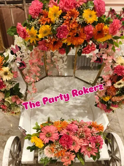 A beautiful flower cart used as a prop for the Minnie Mouse party, filled with colorful fresh flowers that match the event's decor.