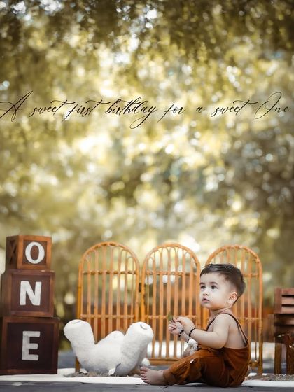 A pensive moment captured during an outdoor first birthday session. The text overlay adds a sweet sentiment to this beautifully composed portrait.