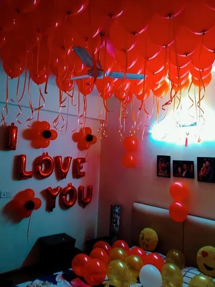 A room filled with red balloons and an 'I LOVE YOU' foil letter sign. This is a classic and powerful way to express your feelings on a special day.