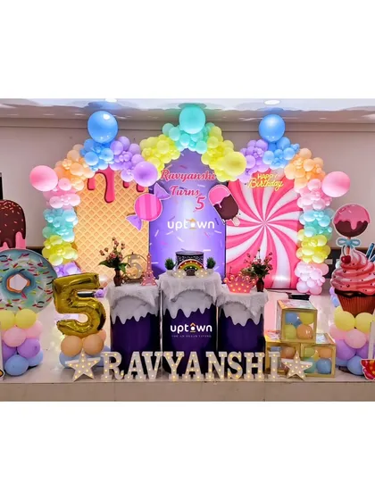 I love creating fun, imaginative worlds for children's parties. This Candyland theme is filled with colorful balloon arches, giant donut and ice cream props, and sweet-themed details for a delightful celebration.