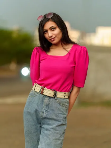 A sweet and simple portrait, with the model looking directly at the camera with a gentle smile.