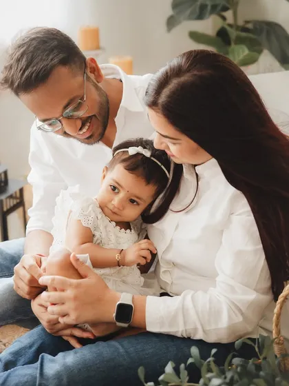 A serene family portrait capturing a quiet moment together. The soft lighting and natural setup in my studio provide the perfect backdrop for these gentle family interactions.