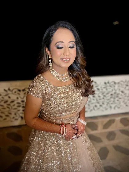 The glam supremacy for Vari's Sangeet. This magical look features a glittering smokey eye and a flawless base, making her shine like a star.