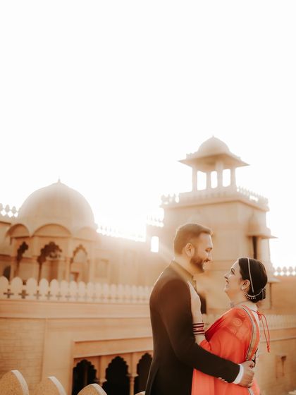 A candid moment of connection as the couple shares a look. The bright backlighting from the sun adds a warm, romantic glow to this heritage pre-wedding photo.