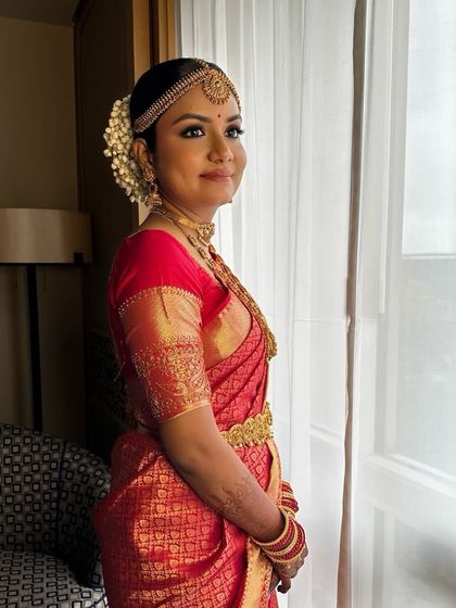 A side profile of Deepika's traditional look. The hairstyle is clean and elegant, designed to hold the heavy jewelry and stay in place for hours.