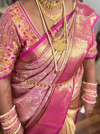 A full view of the saree, showcasing the intricate embroidery on the blouse and the perfect fall of the pleats.