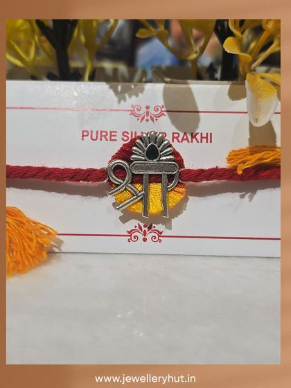 A close-up of our pure silver Rakhi with a "Shri" design. It's more than a thread; it's a keepsake that shines.