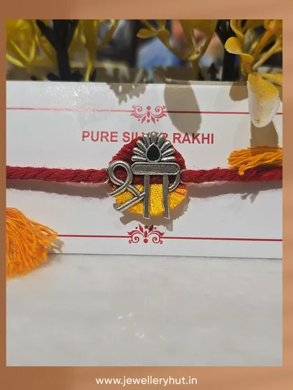 A close-up of our pure silver Rakhi with a "Shri" design. It's more than a thread; it's a keepsake that shines.