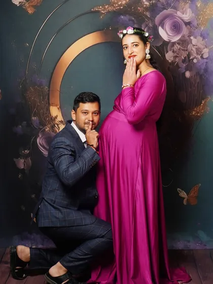 A playful pose from the same maternity shoot, showing the dad-to-be sharing a secret with the baby.