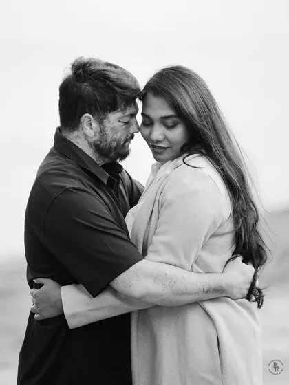Sometimes, the most powerful stories are told without color. This black and white portrait strips away everything but the raw emotion, focusing on the tender, unspoken connection between two people.