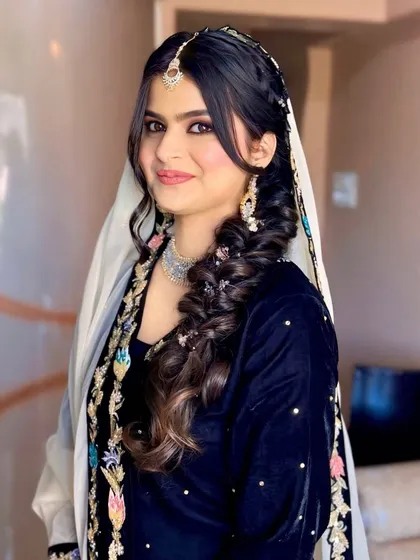 A front view of the Roka bride, her side braid adding a touch of softness to her look.