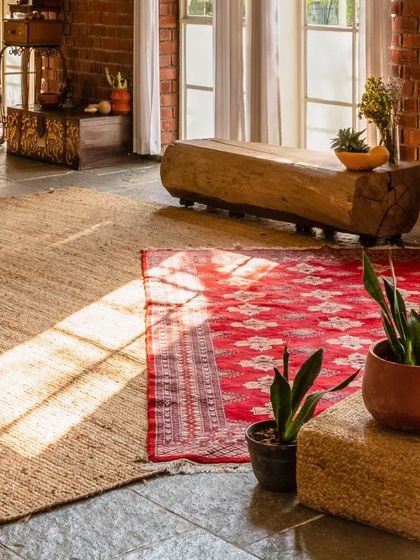 We created many cozy nooks throughout the home, using natural textures like jute and wood. This log bench and layered rugs create an inviting spot to relax.