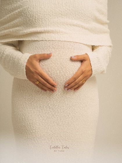 A heart for your baby. This simple, beautiful gesture of hands forming a heart on the bump is a classic for a reason. It's a pure and direct expression of love.