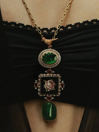 My classic rose pendant, handcrafted with a micromosaic center, Zambian emeralds, and rubies. The design is meant to be a timeless piece that can be passed down through generations.