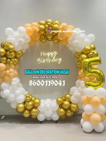 This elegant circular balloon frame was for a 56th birthday celebration in an office space. The mix of chrome gold, peach, and white balloons creates a sophisticated photo backdrop, complete with large foil numbers.