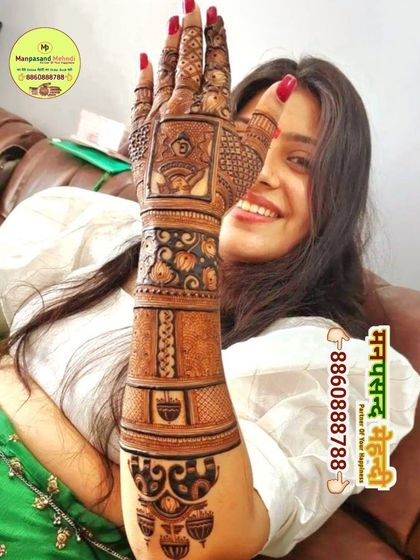 A happy client showing off her beautiful Karwa Chauth mehndi. The design is a mix of traditional symbols and modern patterns, perfect for the festival.