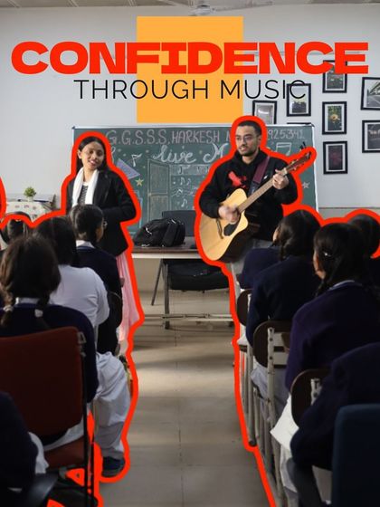 "Confidence Through Music." An instructor and a student stand at the front of the class, leading a session together. This demonstrates the confidence our students build to lead their peers.