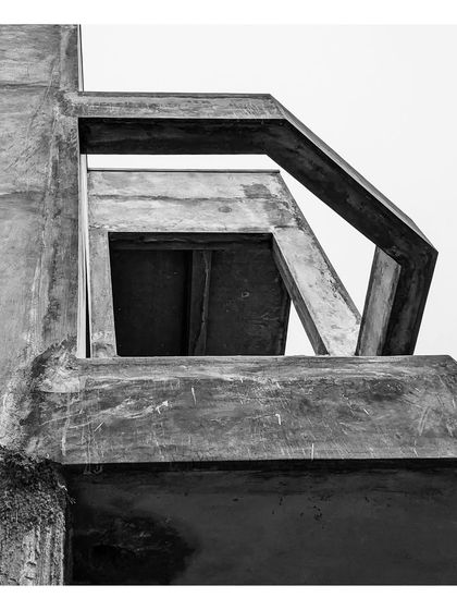 An abstract, black and white detail of the concrete facade at '15B HSR'.
