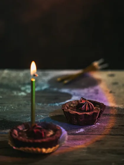 Another version of the birthday tart scene, with the candle lit and a rainbow light effect, creating a magical and celebratory mood.