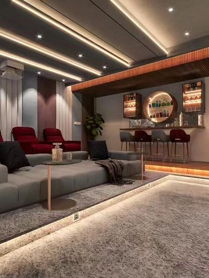 This design concept is for a dedicated home theater and entertainment room. It includes plush recliner seating, a full bar area in the back, and sophisticated ceiling and floor lighting for an immersive cinematic experience.