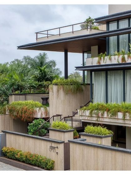 The overall composition of the Indore villa, with its deep overhangs and integrated greenery, is a powerful statement of modern residential design.